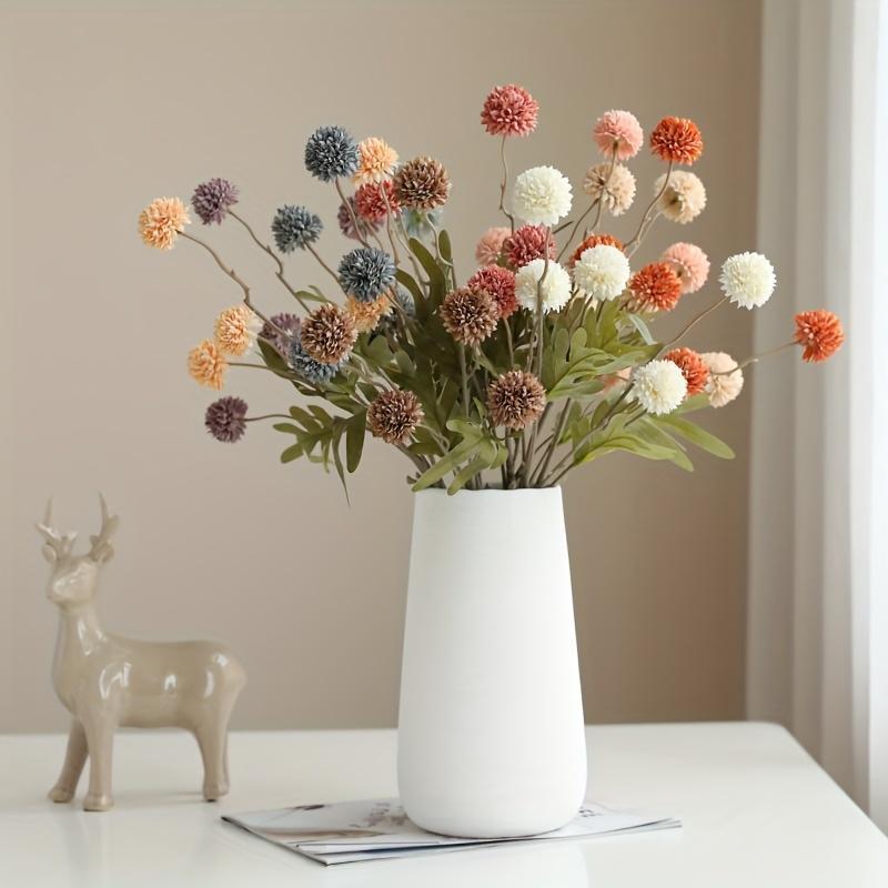 Simulated European-style dandelion decoration with artificial flowers in various styles.