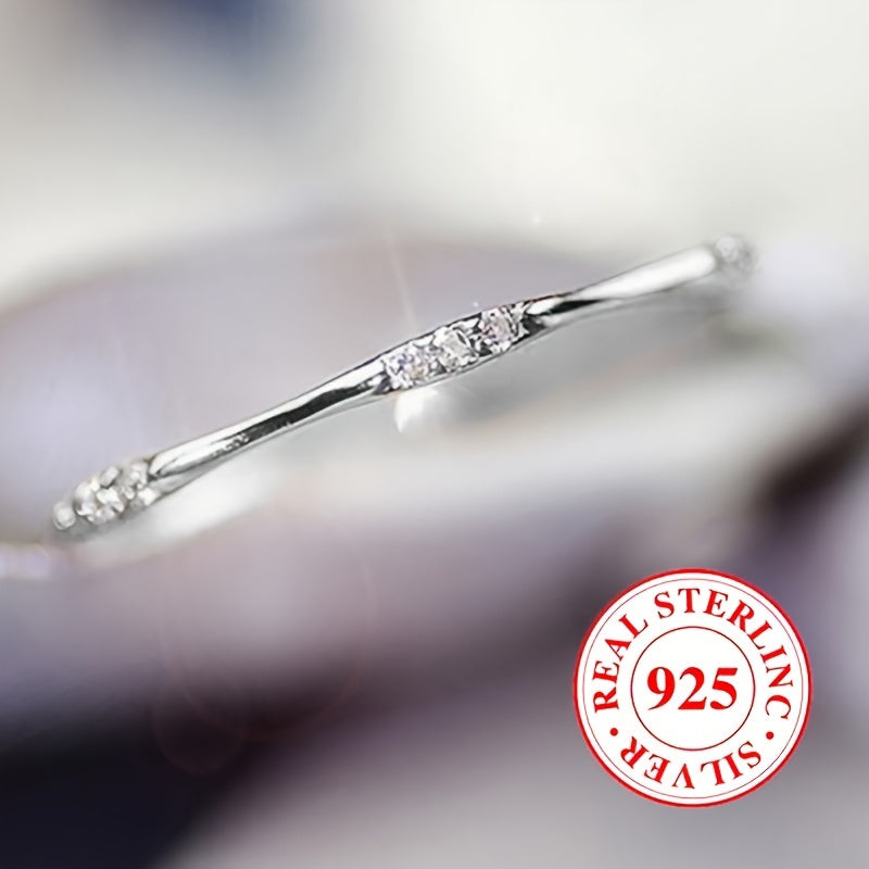 A sleek ring using only 1 gram of 925 sterling silver, embellished with shimmering zirconia, ideal for everyday wear or special occasions such as weddings.