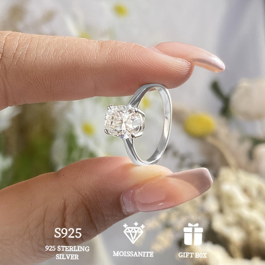 A hypoallergenic wedding or engagement ring gift for women, featuring a 2 carat goose egg Moissanite stone set in a classic four-prong 925 Sterling Silver ring. Includes Moissanite certificate and comes in an exquisite gift box.