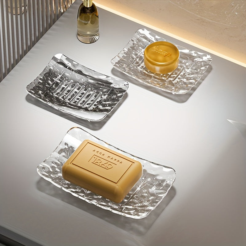 Set of two clear glass soap dishes in sizes large and small with a textured design, made of plastic and does not require electricity.