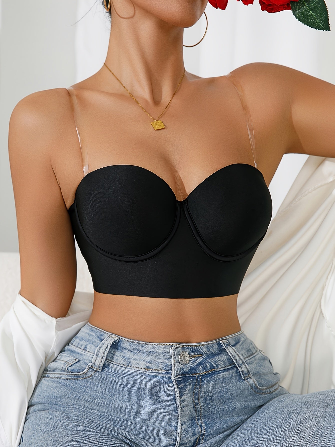 Black push-up bra with transparent straps, underwire support, and non-removable pads for comfort and casual wear.