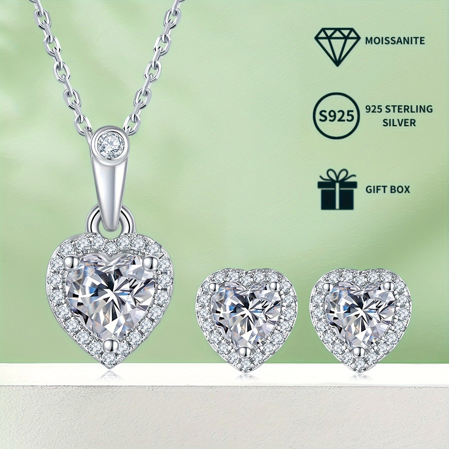 A set of elegant women's jewelry includes a pair of heart-shaped s925 silver earrings featuring 0.5ct*2 moissanite stones, a 1.0ct moissanite pendant necklace, and a matching necklace chain. The set weighs 2.88g for the necklace and 1.58g for the