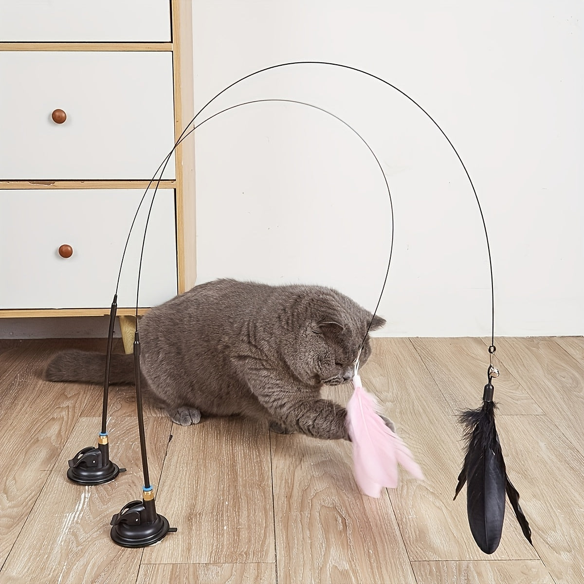 Durable plastic teaser toy with suction cup and long pole for indoor cats, no batteries needed.