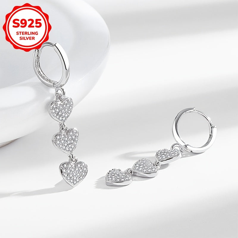 These exquisite ladies' earrings feature dazzling heart-shaped pendants embellished with synthetic zirconia, set in 925 silver. Weighing 3.6g, they are perfect for both daily wear and special occasions such as banquets.