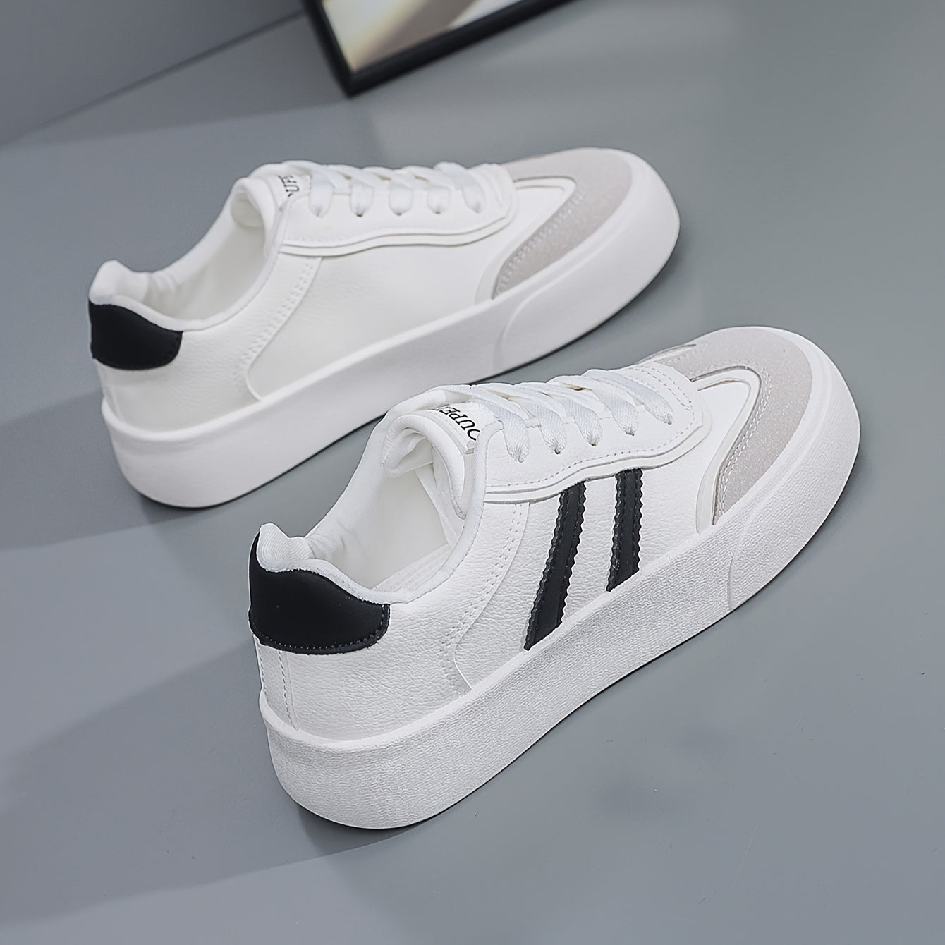 Women's lightweight white sneakers with beige accents are comfortable all-season footwear with a trendy classic design.