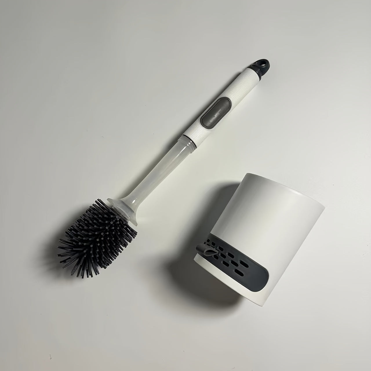 Introducing the innovative Silicone Toilet Brush Set with Water-Holding Base and Diatom Mud Mat. This set includes a Drawer Toilet Brush with a refillable handle dispenser, making it the perfect addition to your bathroom accessories. And to top it off