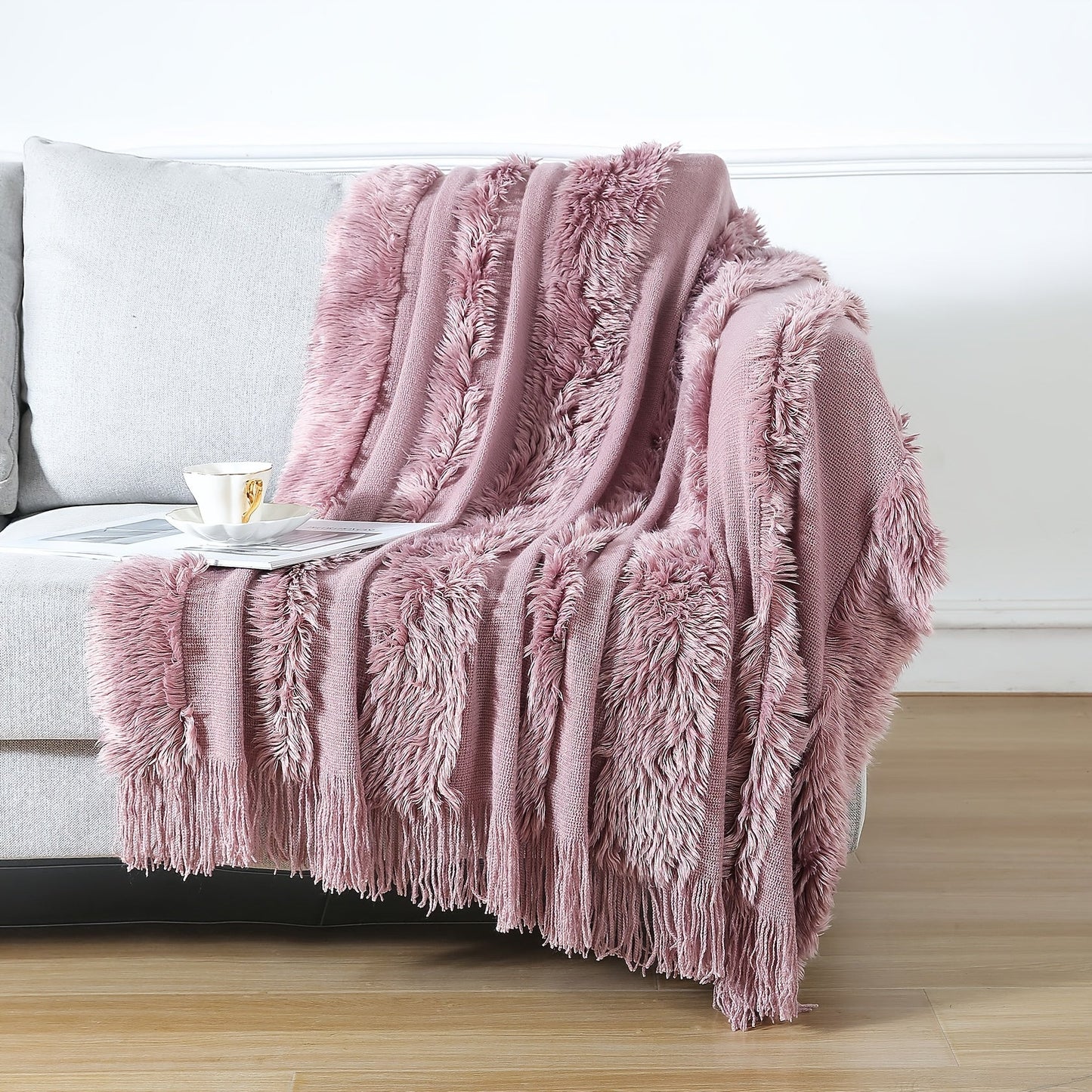 Stay cozy with this contemporary acrylic chunky knit throw blanket featuring tassels. With its solid pattern, lightweight plush texture, and machine washable design, this all-season throw is perfect for adding a touch of style and comfort to your couch