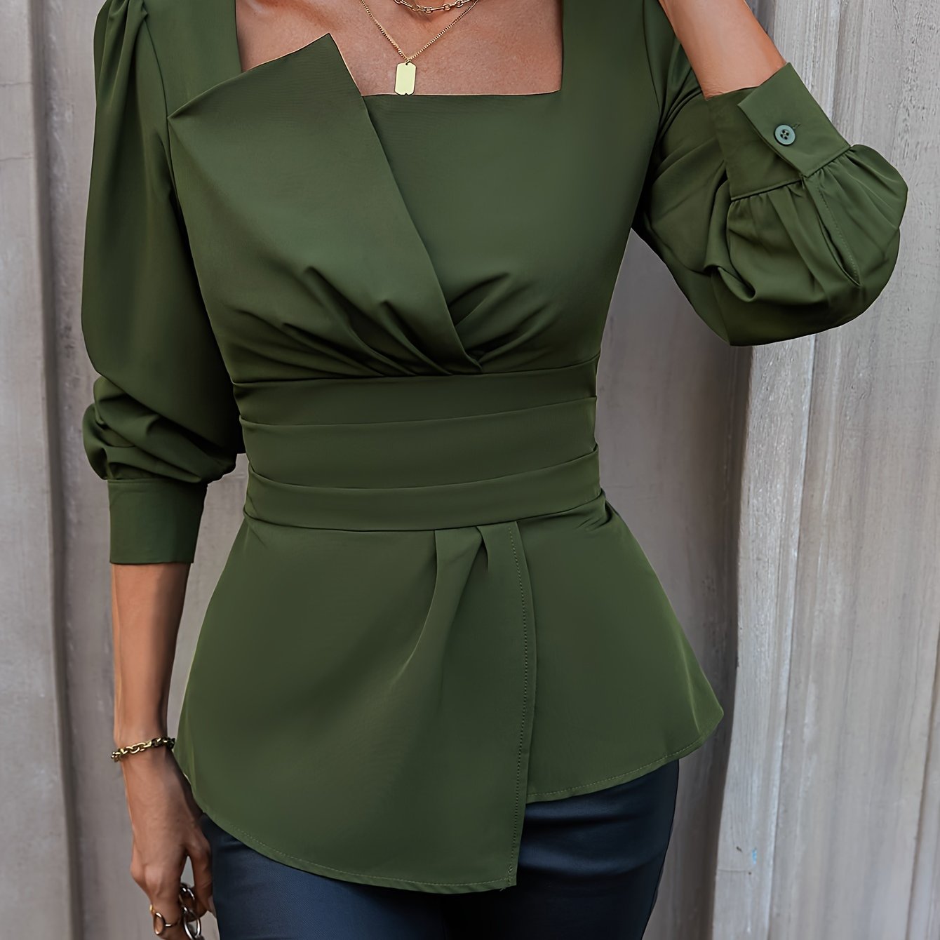 Sophisticated olive green blouse with square neckline, puffed sleeves, and asymmetric hem. Ideal for spring and summer, machine washable and dry cleanable.