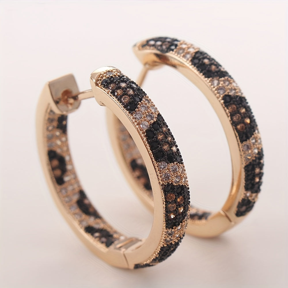 A set of stylish retro leopard print earrings with three rows of zirconia stones, crafted in copper for a bold and trendy look. These earrings are perfect for adding a touch of luxury to any outfit, and make a great gift for birthdays or just to treat