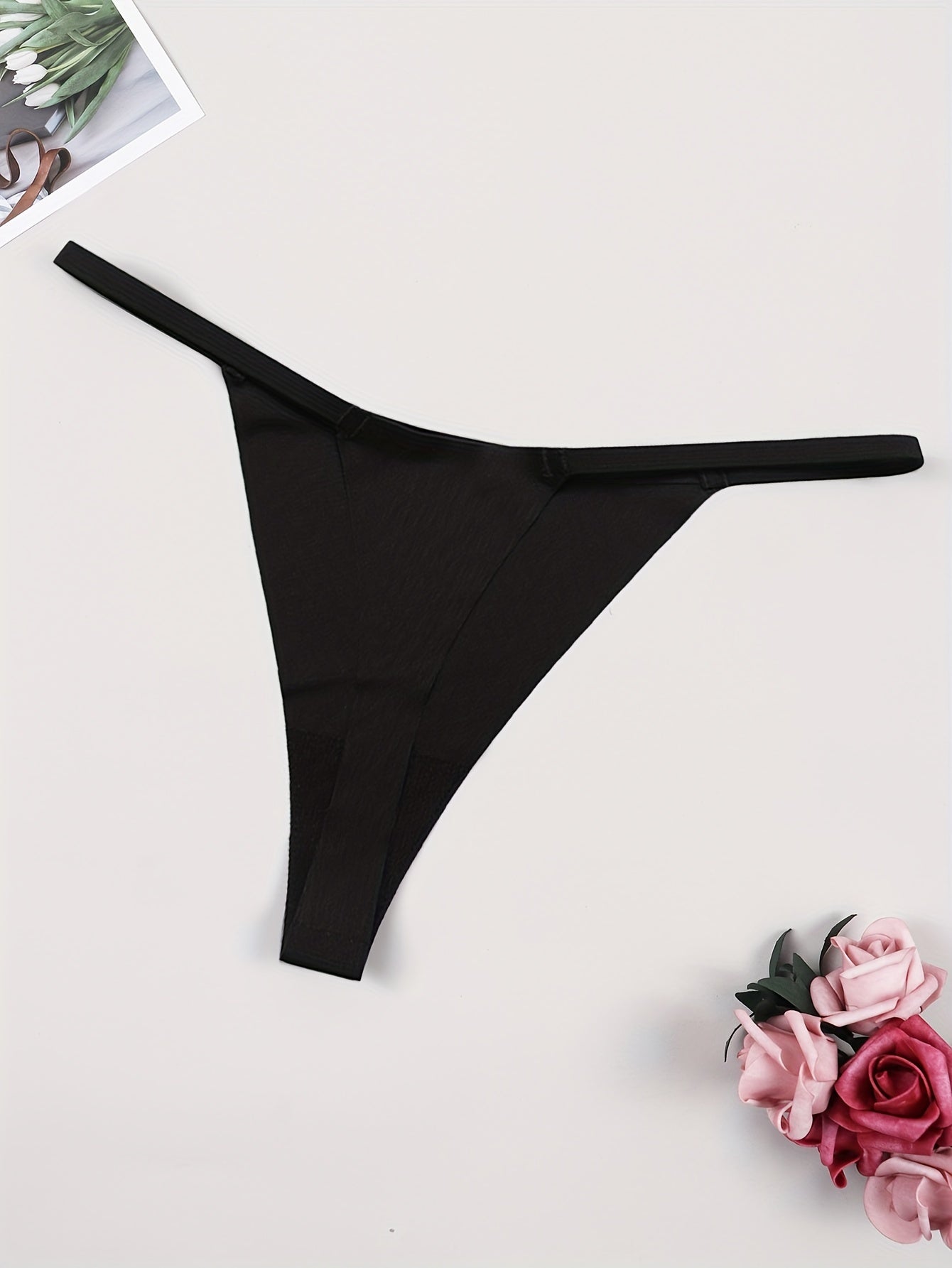 Sexy women's thong underwear featuring donut print and fun letter graphic, made of breathable quick-dry nylon fabric.