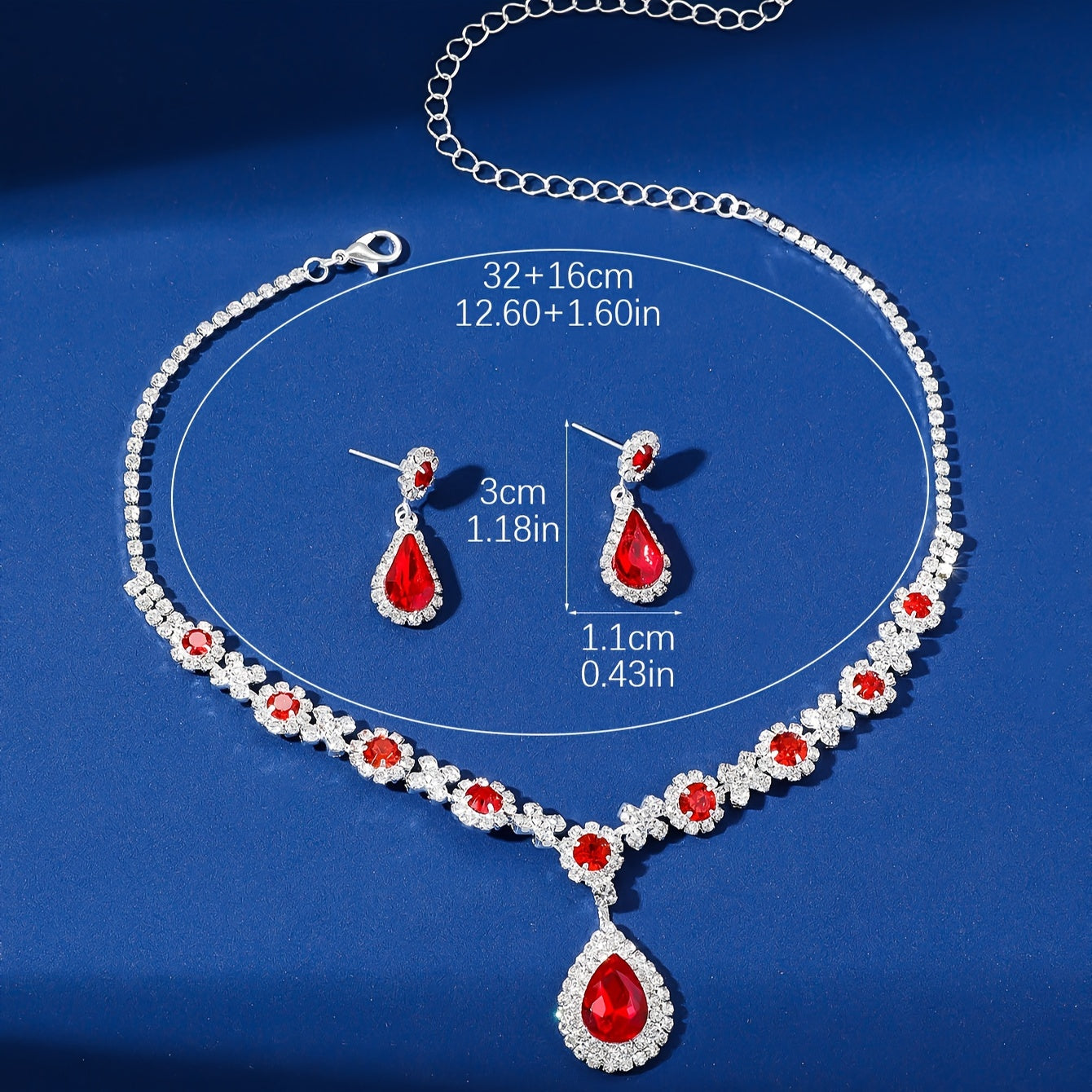 Stylish and opulent silver plated necklace and earrings set adorned with red rhinestone flower detailing and teardrop pendants. This elegant copper fashion jewelry set is designed for women, ideal for parties, banquets, and Valentine's Day. A versatile