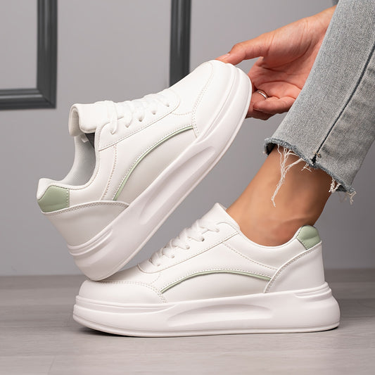 Women's white skate shoes with round toe, lace up closure, and low top flat design. Comfortable for casual wear and sports.