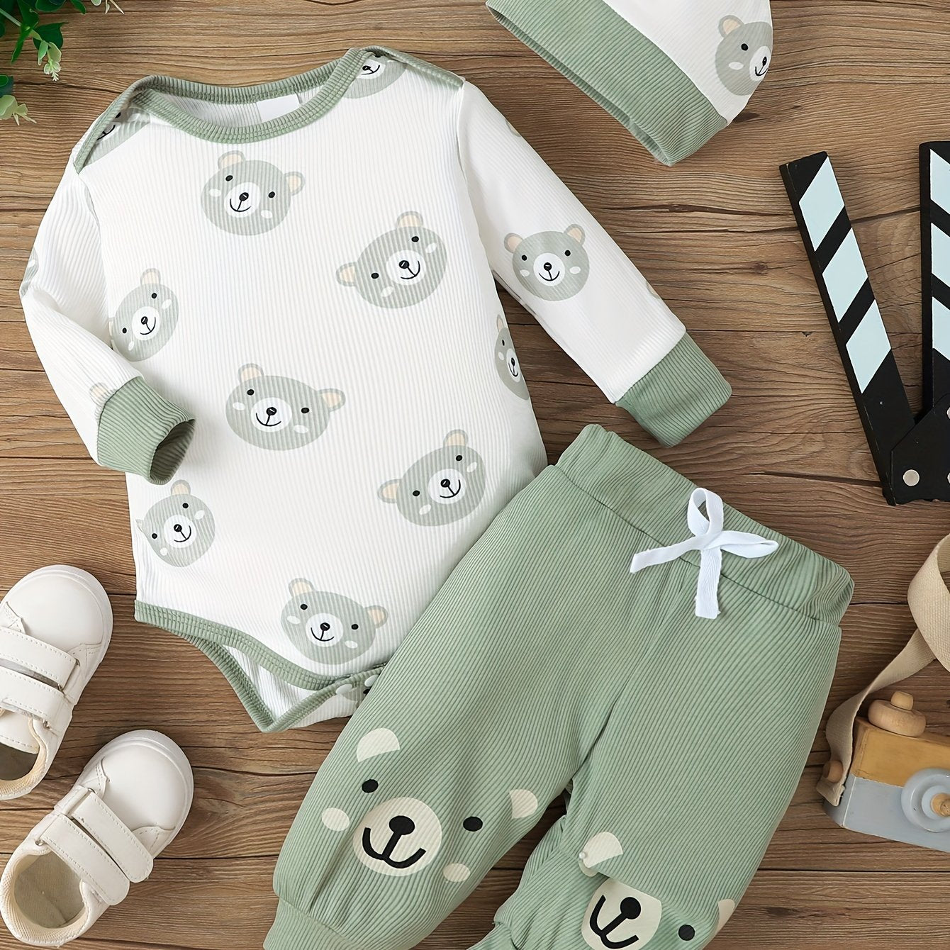 Baby's cute bear print three-piece set, includes romper, trousers, and hat. Soft and comfortable for newborns, perfect for outdoor wear.