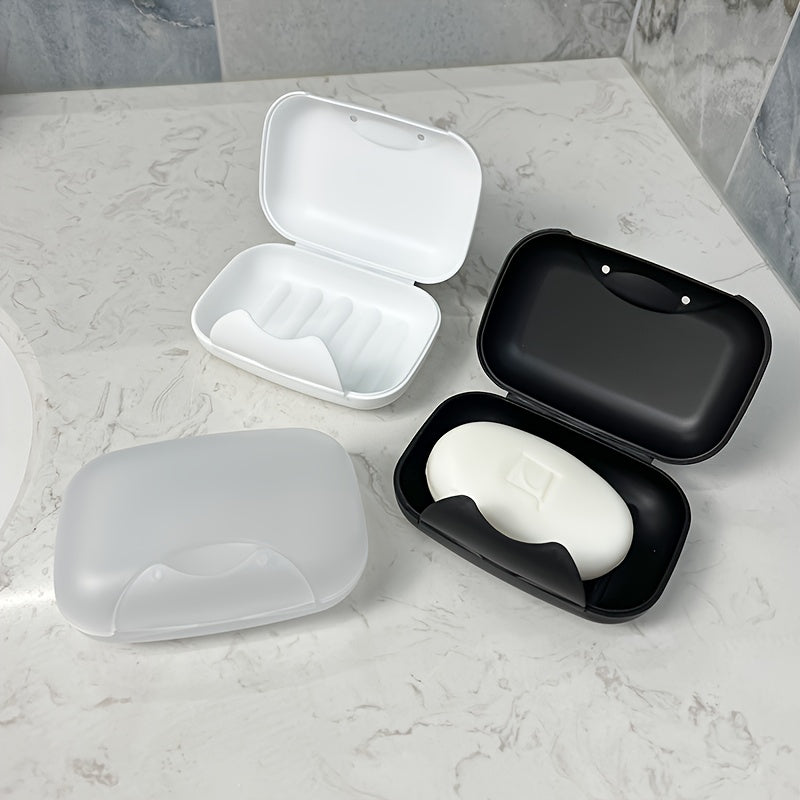 Travel-friendly plastic soap dish with lid, for convenient soap storage in the bathroom.