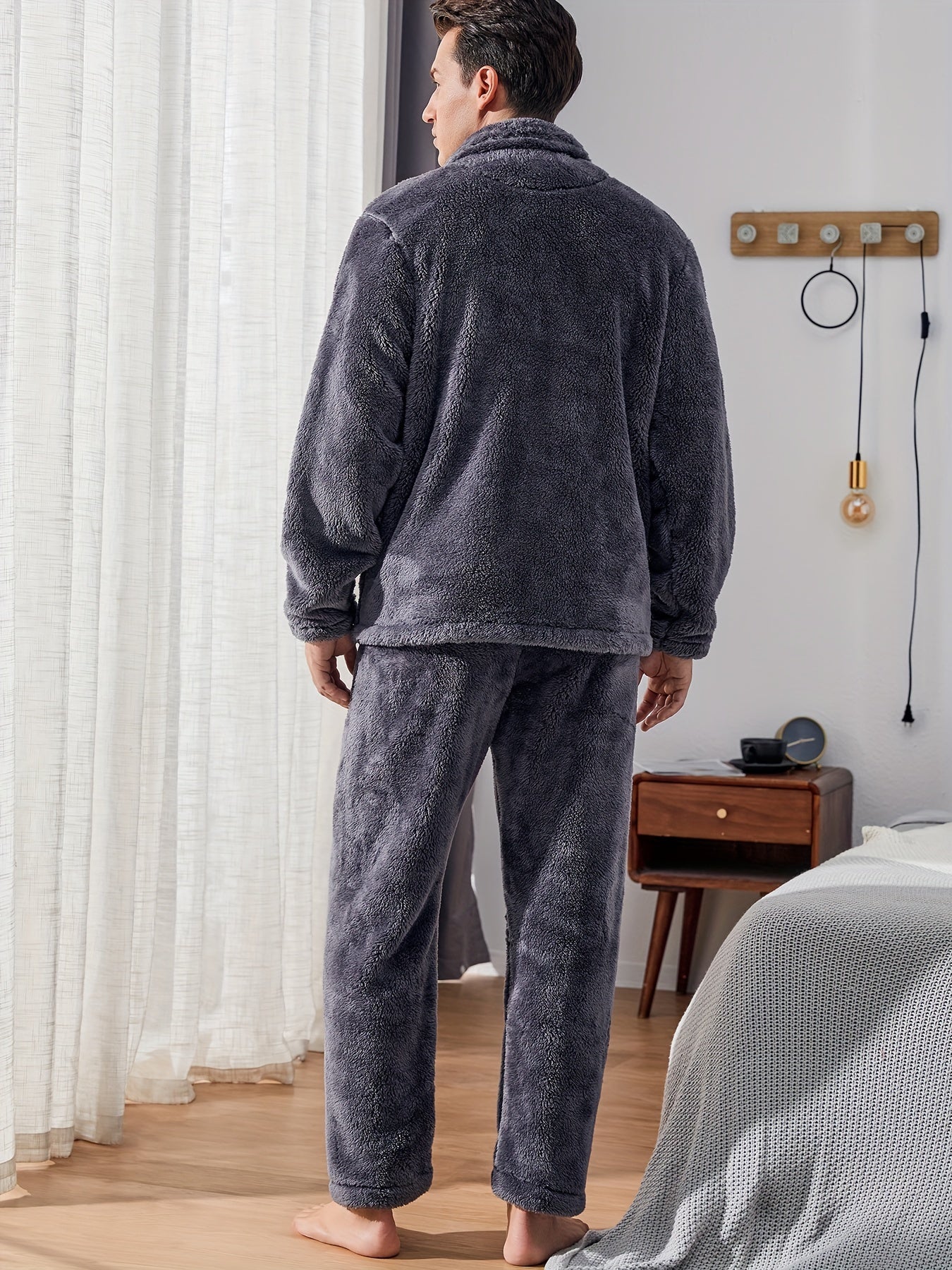 Warm and cozy men's fleece pajama set with pockets, perfect for winter. Features long sleeve top and pants. Machine washable.