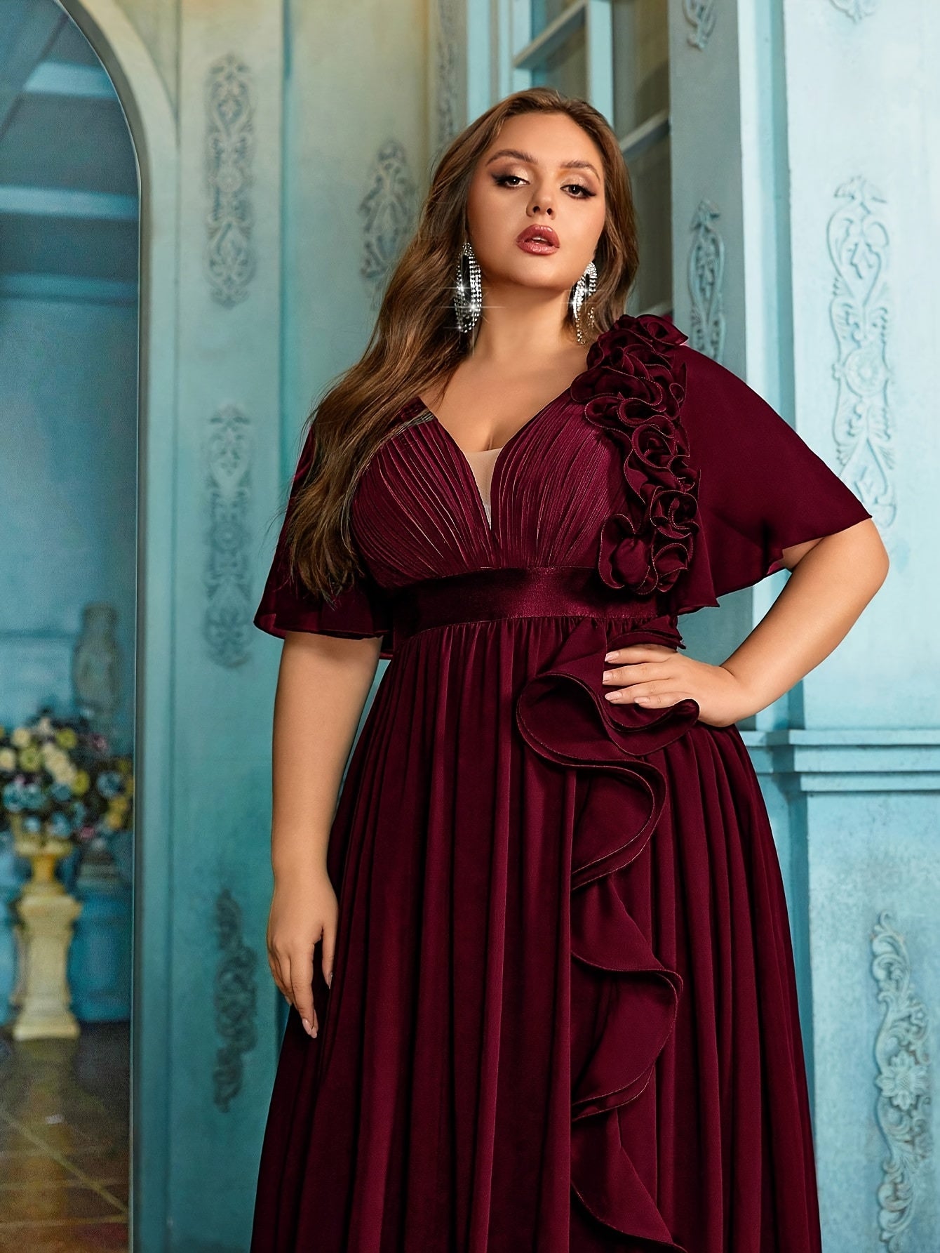 Stylish Plus Size Black Chiffon Evening Gown with V-Neck, 3D Floral Detail, Ruffled Hem, Short Sleeves, and High Waist. Perfect for weddings, graduations, and formal occasions.