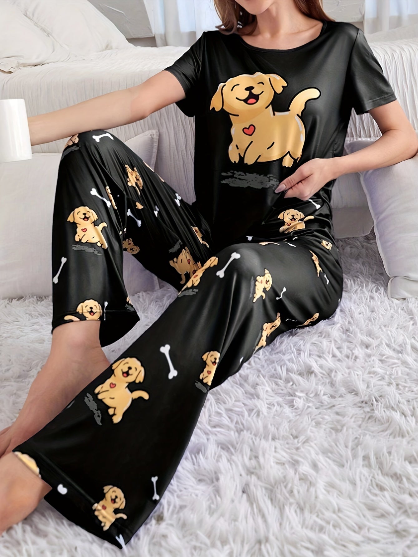 Women's sleepwear set with cute puppy print, short sleeve top, and elastic pants.