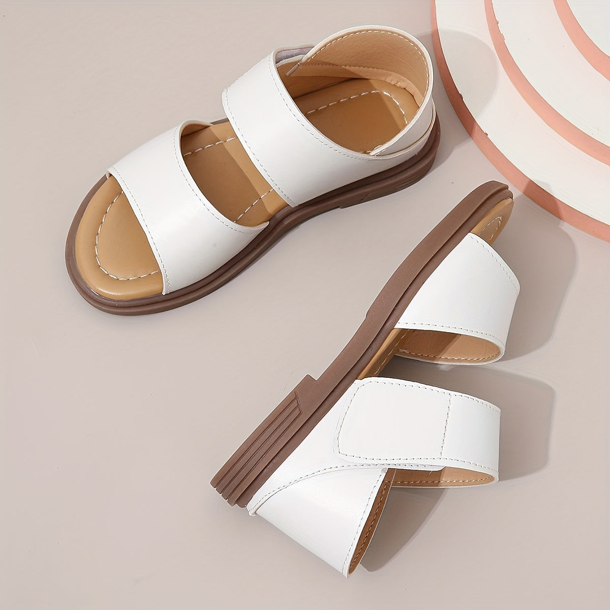 Stylish summer sandals for girls: open-toe design with braided straps and flat sole, ideal for casual wear and festivals.