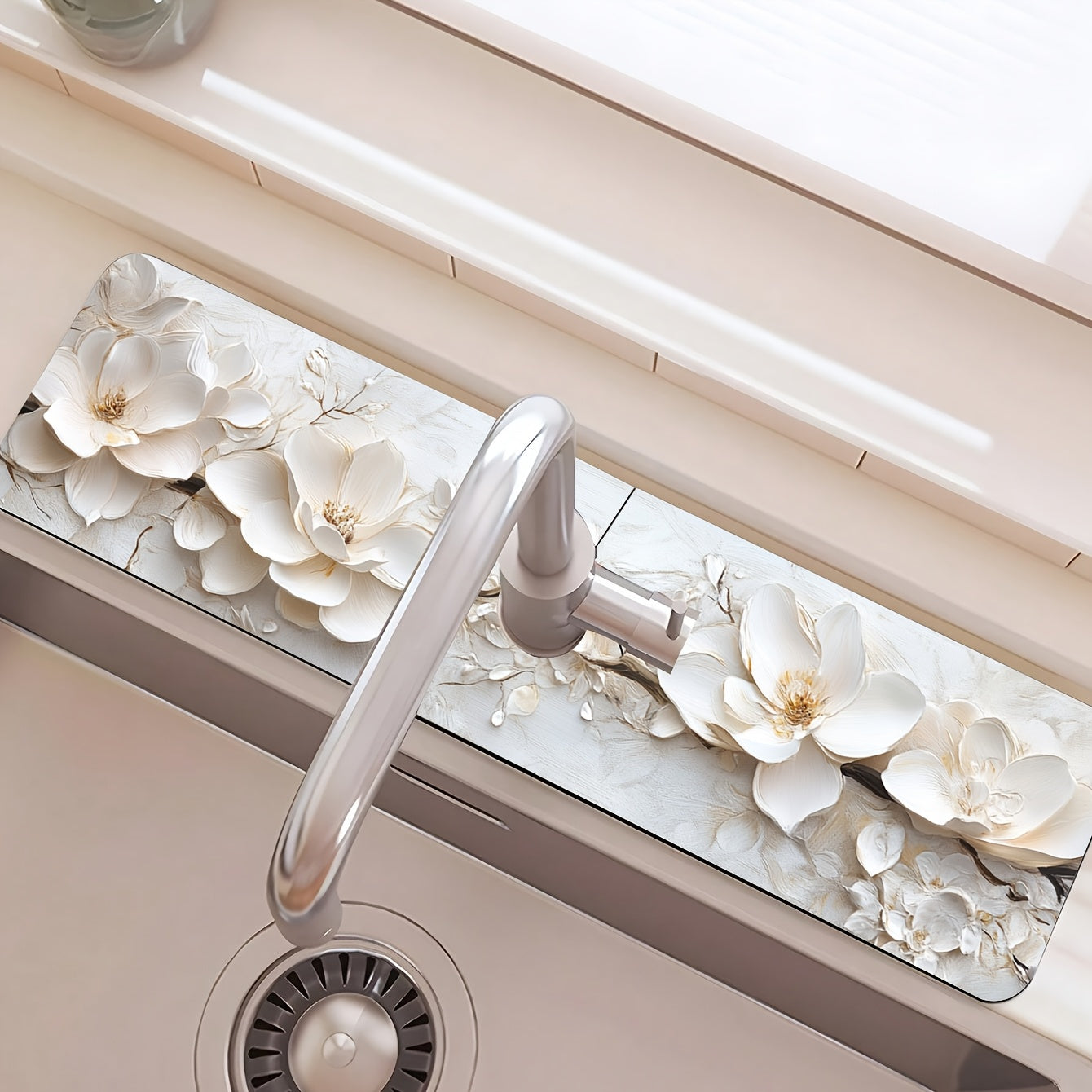 Add a touch of elegance to your kitchen or bathroom with this 3D floral faucet mat in white. Made of durable and moisture-proof polyester, it is splash absorbent and features a suction cup for easy installation. Perfect for adding some style to your