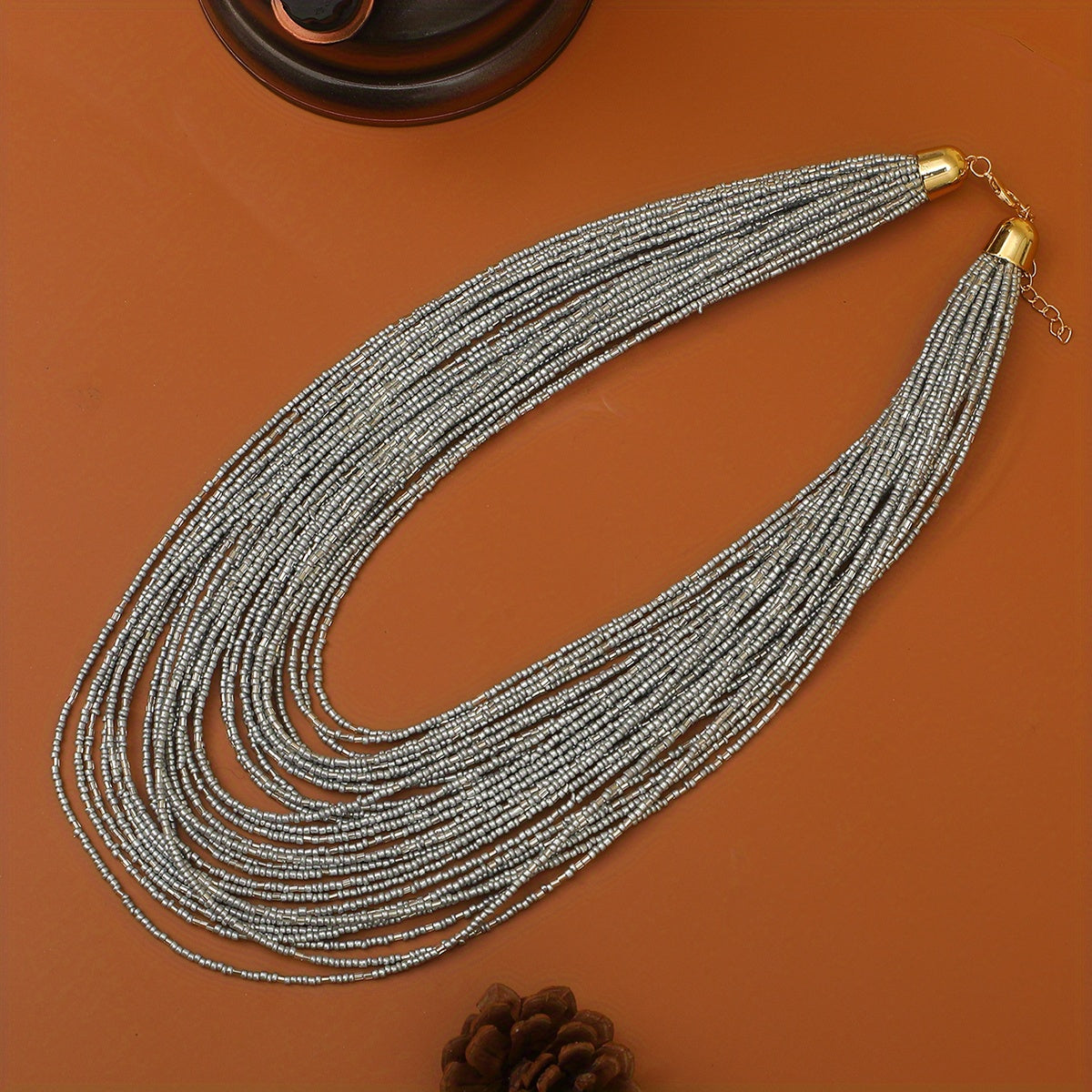 A trendy and flexible millet bead necklace with multiple layers.