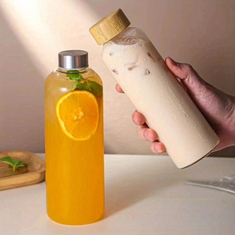 This borosilicate glass bottle comes with both a stainless steel lid and a wooden bamboo lid, making it perfect for travel and storing a variety of beverages such as juice, smoothies, kombucha, kefir, and tea. It is 100% leakproof and can be safely used