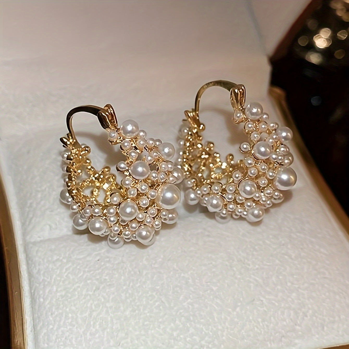 Elegant French-style U-shaped hoop earrings featuring faux pearls and beads, with a delicate hollow-out design ideal for women. A must-have accessory for vacations and parties.