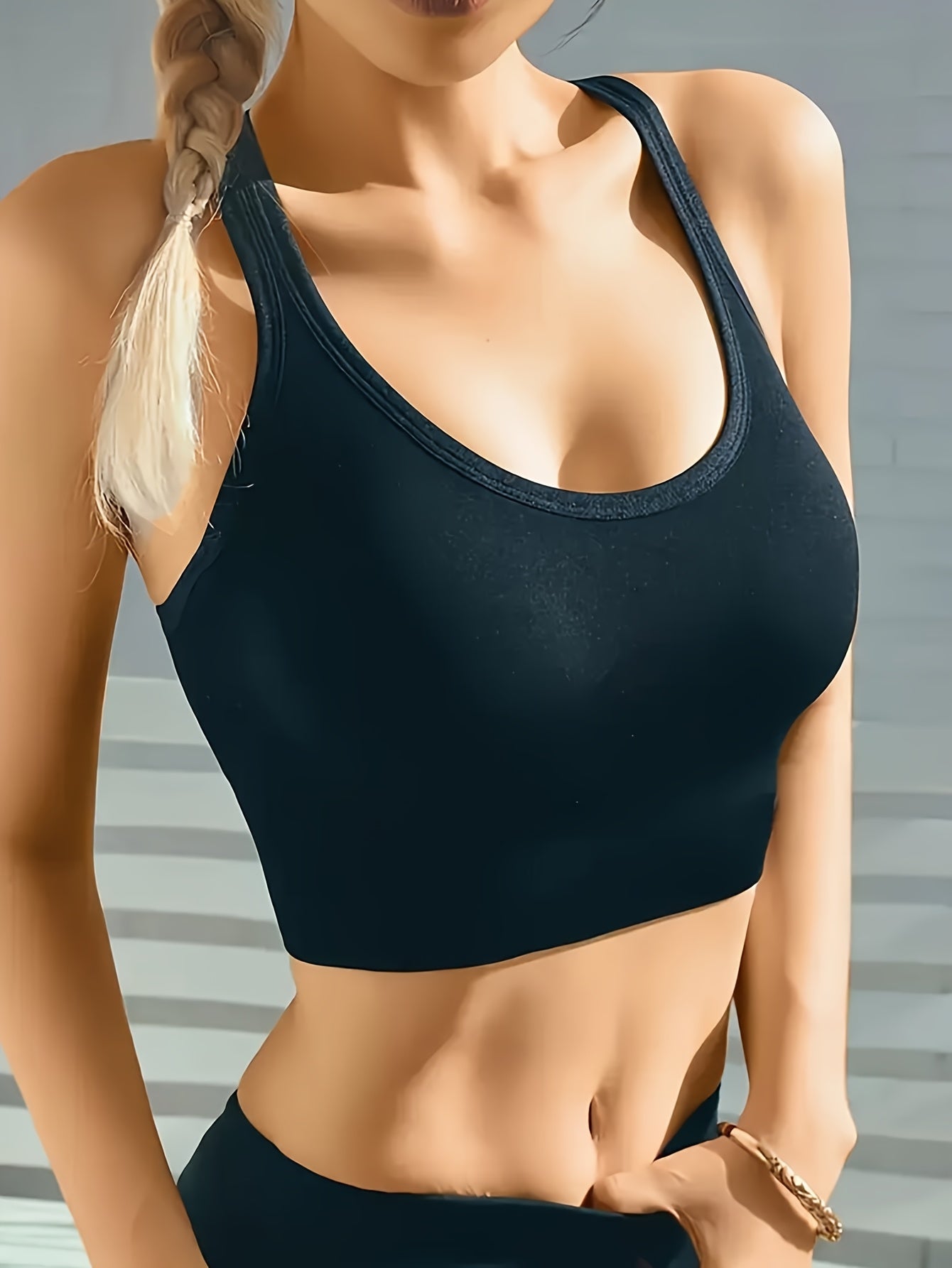 High-support sports bra for women with adjustable back buckle, removable pads, and cross-back design. Great for yoga, fitness, and running. Made with breathable nylon fabric.