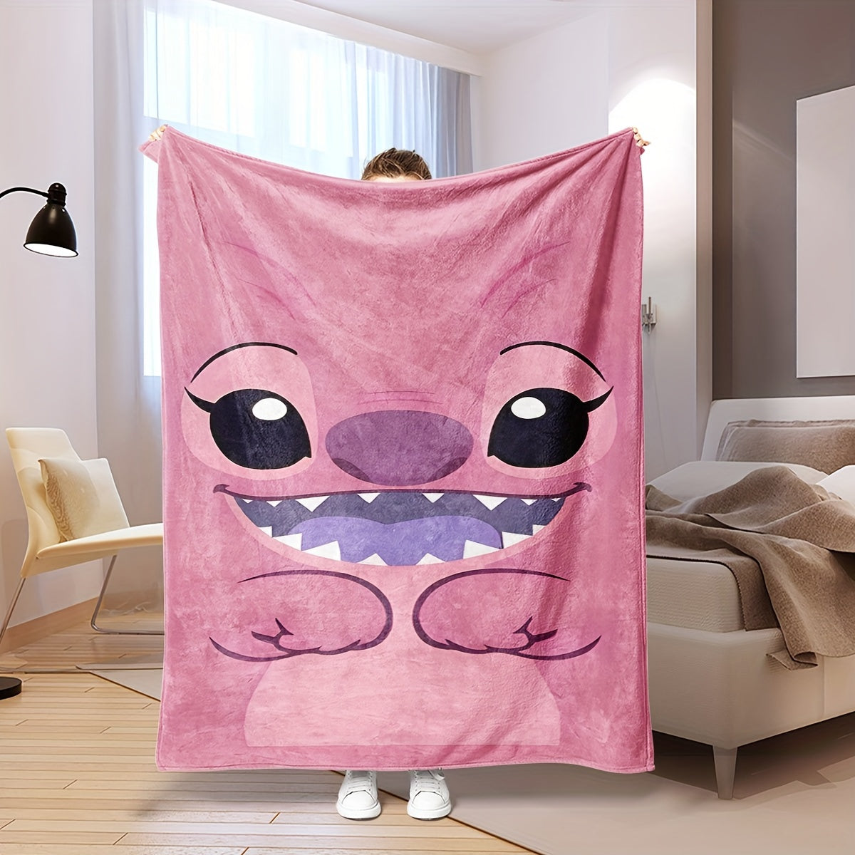 Pink plush throw blanket featuring a contemporary cartoon design. Made from soft polyester knit fabric, this multipurpose bedding is suitable for all seasons. Perfect for adding comfort to your bed, sofa, office nap, or as a travel blanket. Makes an