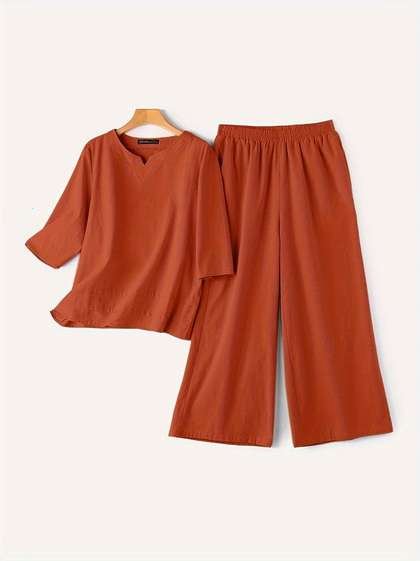 Plus size women's 2-piece outfit with V-neck top, 3/4 sleeves, and pockets. Features soft, breathable fabric and elastic waist wide leg trousers for comfortable lounge wear.