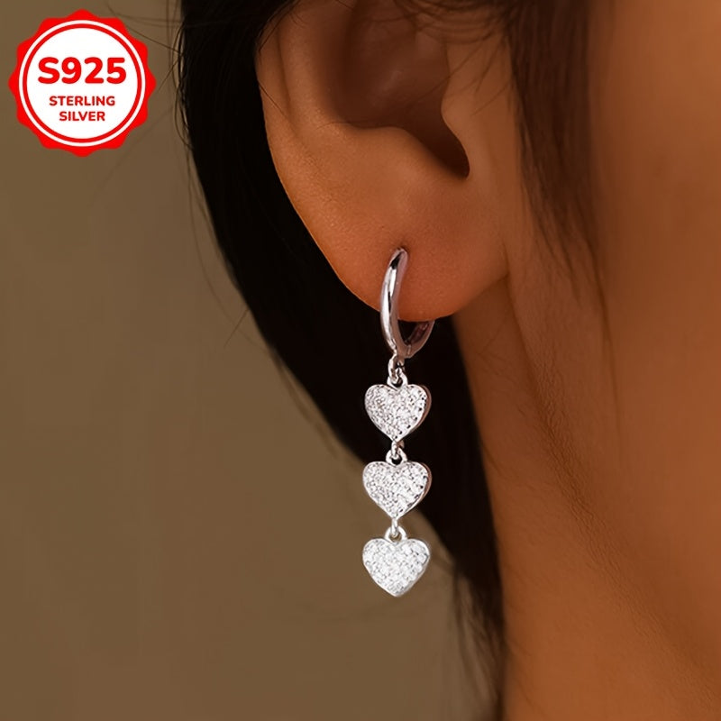 These exquisite ladies' earrings feature dazzling heart-shaped pendants embellished with synthetic zirconia, set in 925 silver. Weighing 3.6g, they are perfect for both daily wear and special occasions such as banquets.