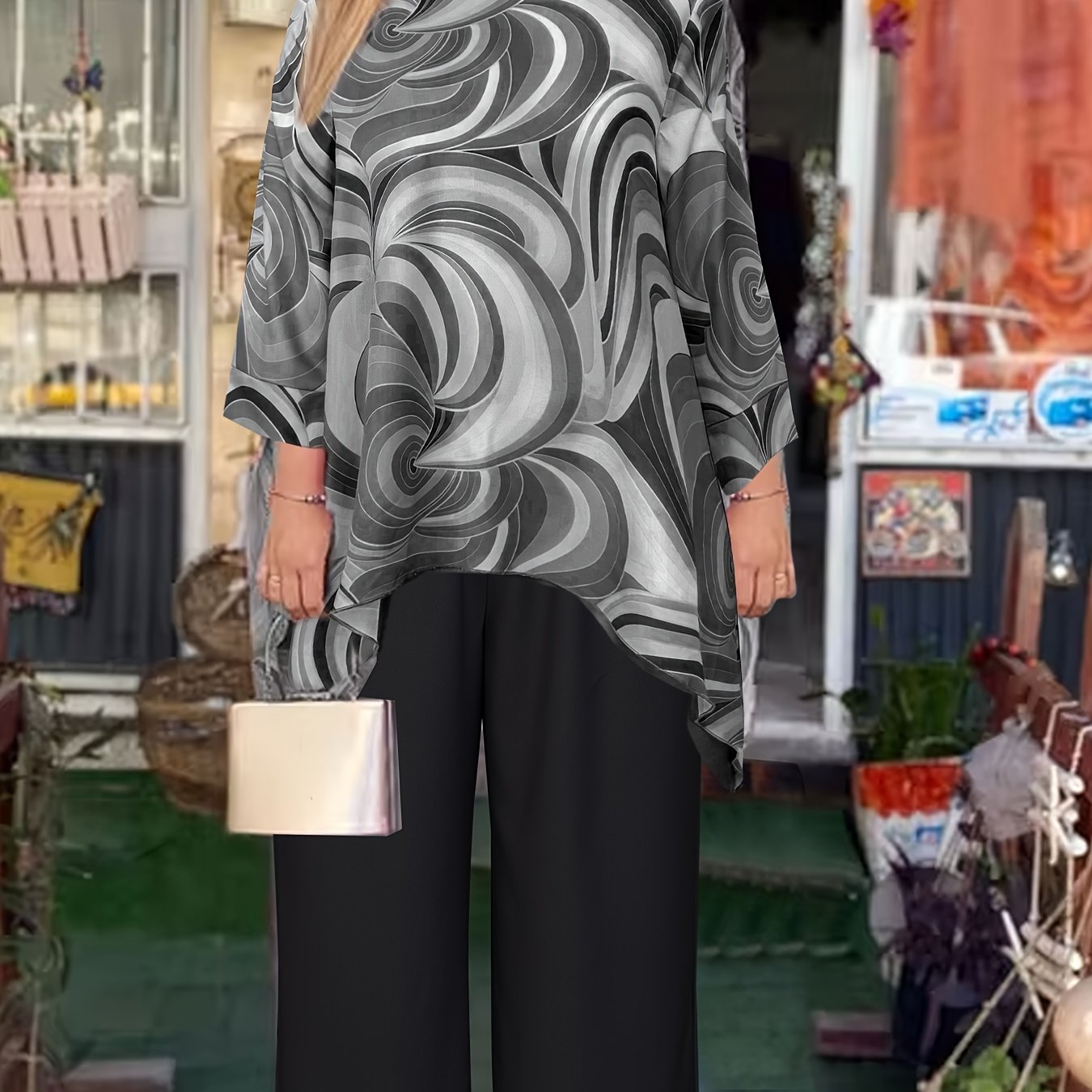 Elegant women's two-piece outfit featuring abstract swirl print round neck top paired with solid black pants. Made of polyester blend and machine washable.