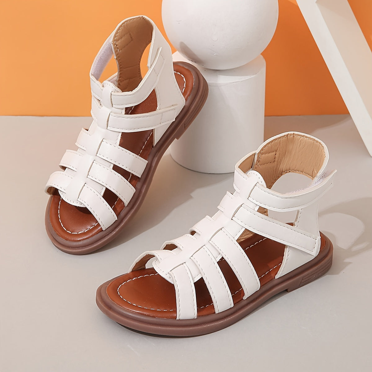 Ivory sandals for girls with brown sole, ideal for school and leisure activities.