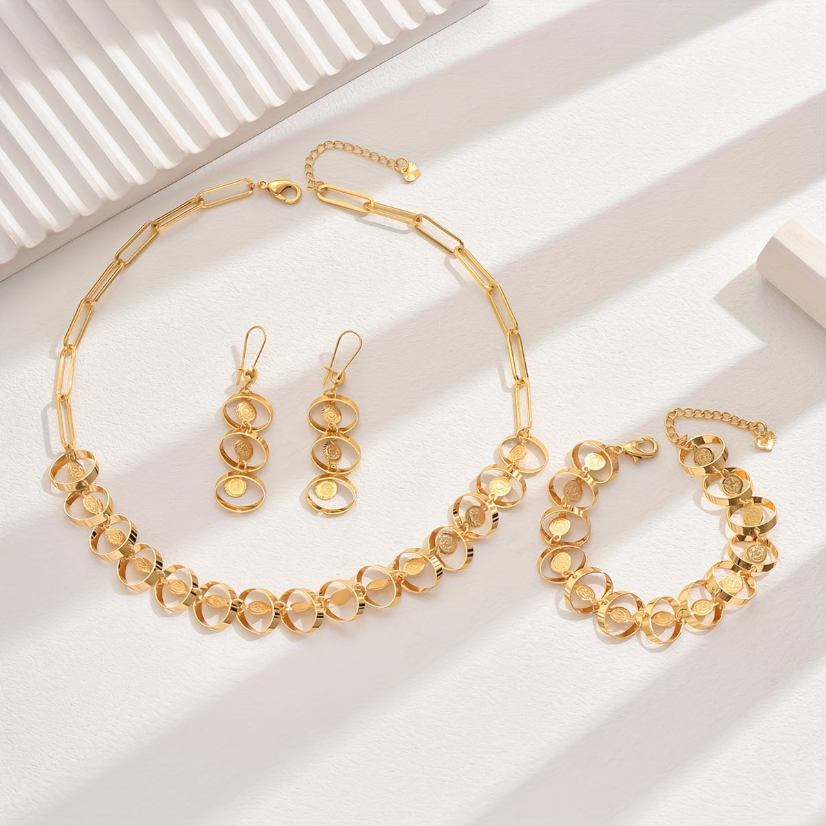 Set of four exquisite and elegant vintage-inspired women's jewelry pieces in 18K gold plating, perfect for a fashionable banquet. Includes a necklace, earrings, bracelet, and ornament.