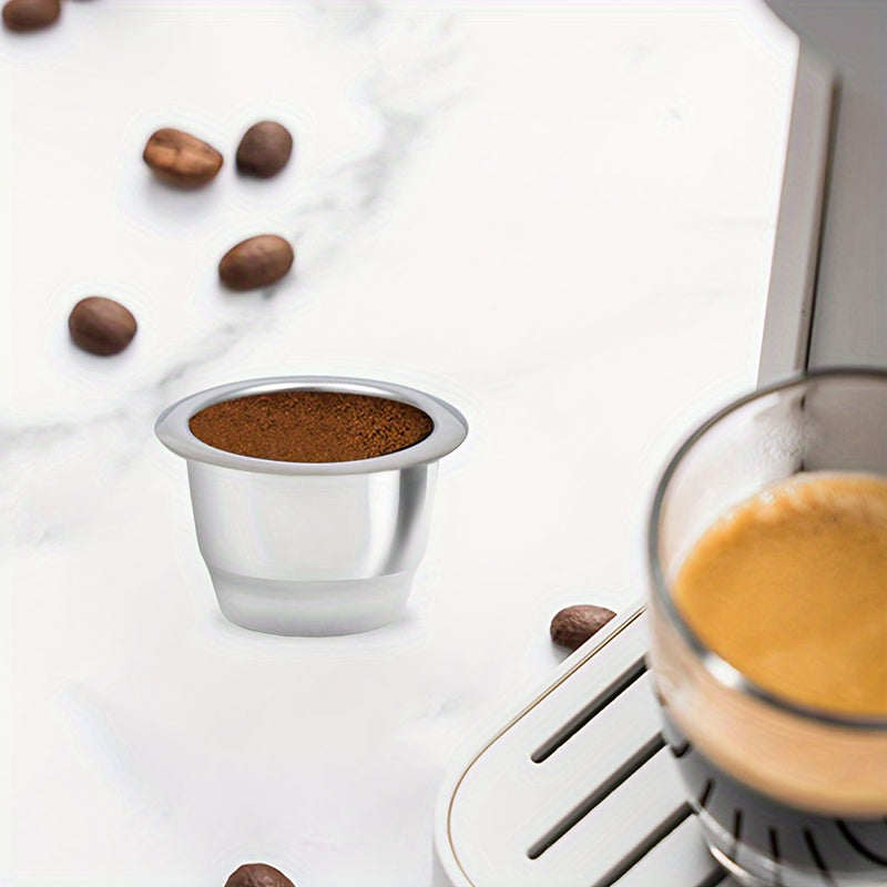 Reusable stainless steel Nespresso coffee capsule for home baristas, designed with a conical shape and flat bottom for improved brewing. Made with high-quality materials for a refillable and environmentally friendly option.