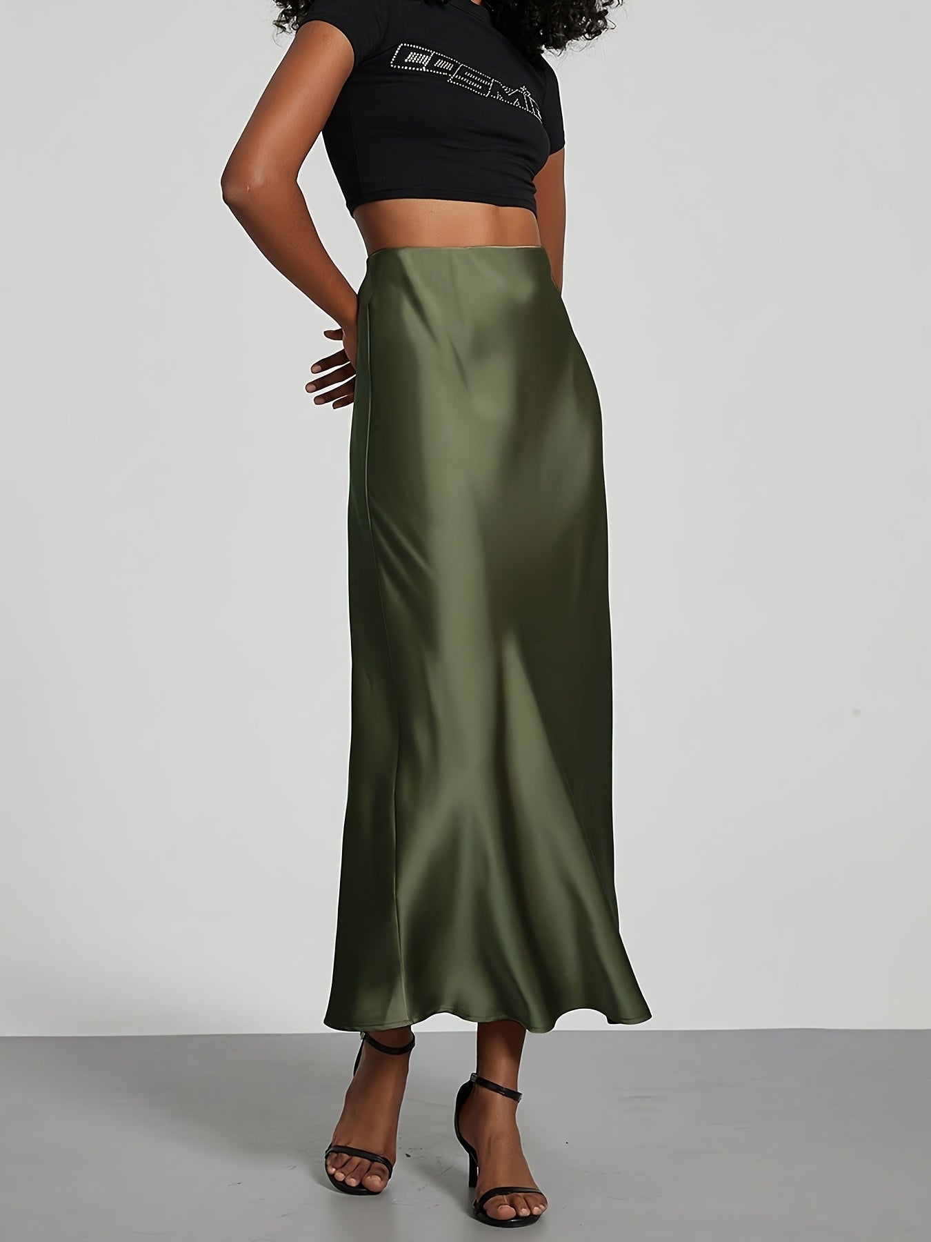 Elegant black high-waisted maxi skirt with A-line cut and smooth satin fabric, perfect for any occasion. Casual chic at its best.