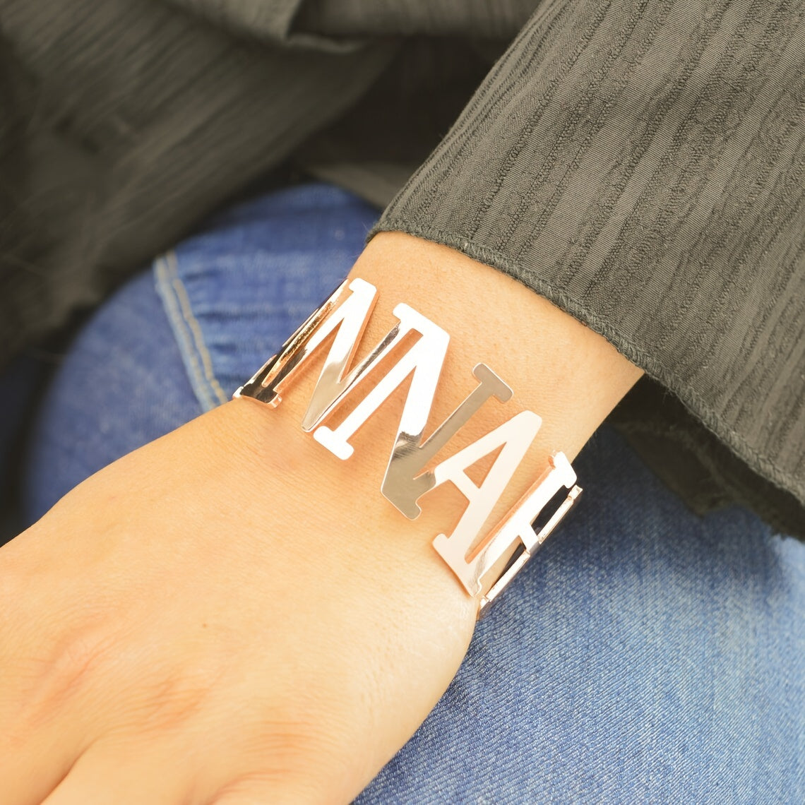 Customize your look with this chic and simple stainless steel cuff bracelet. This adjustable bangle features a custom name engraving, making it perfect for both casual attire and special occasions. Add a touch of elegance to your outfit with this large