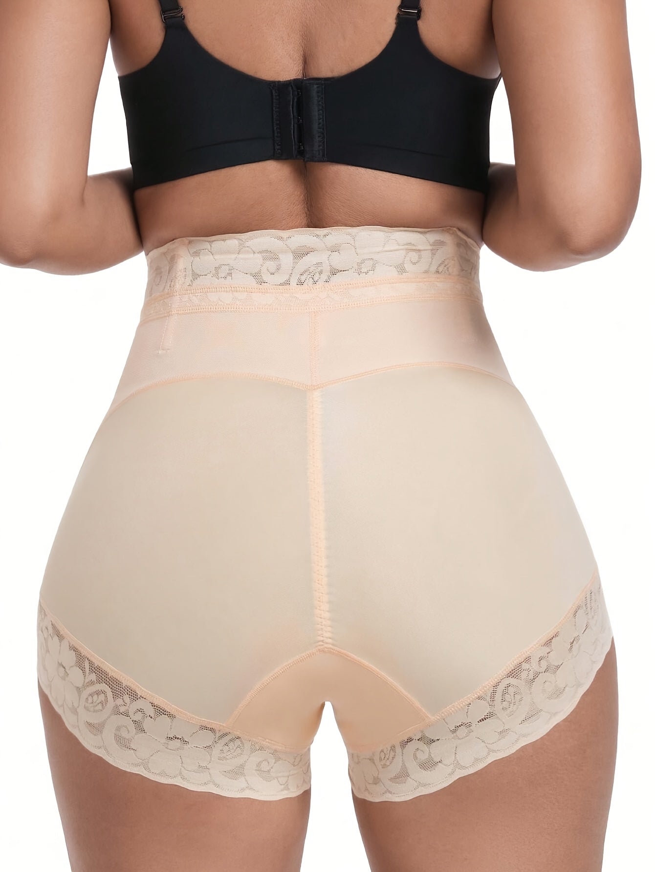 High-waisted shaping shorts for women with tummy control and butt lifting features. Made of stretch nylon with floral lace trim, in beige color. Hand wash only. Cute panties.