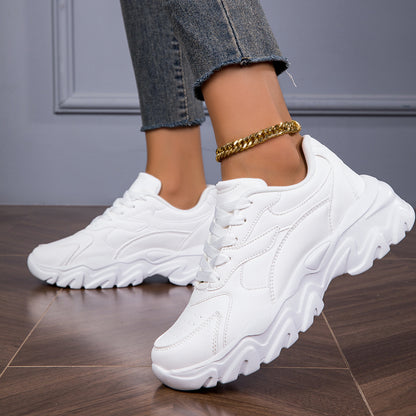 Women's white low-top lace-up sneakers for casual walks and shopping.