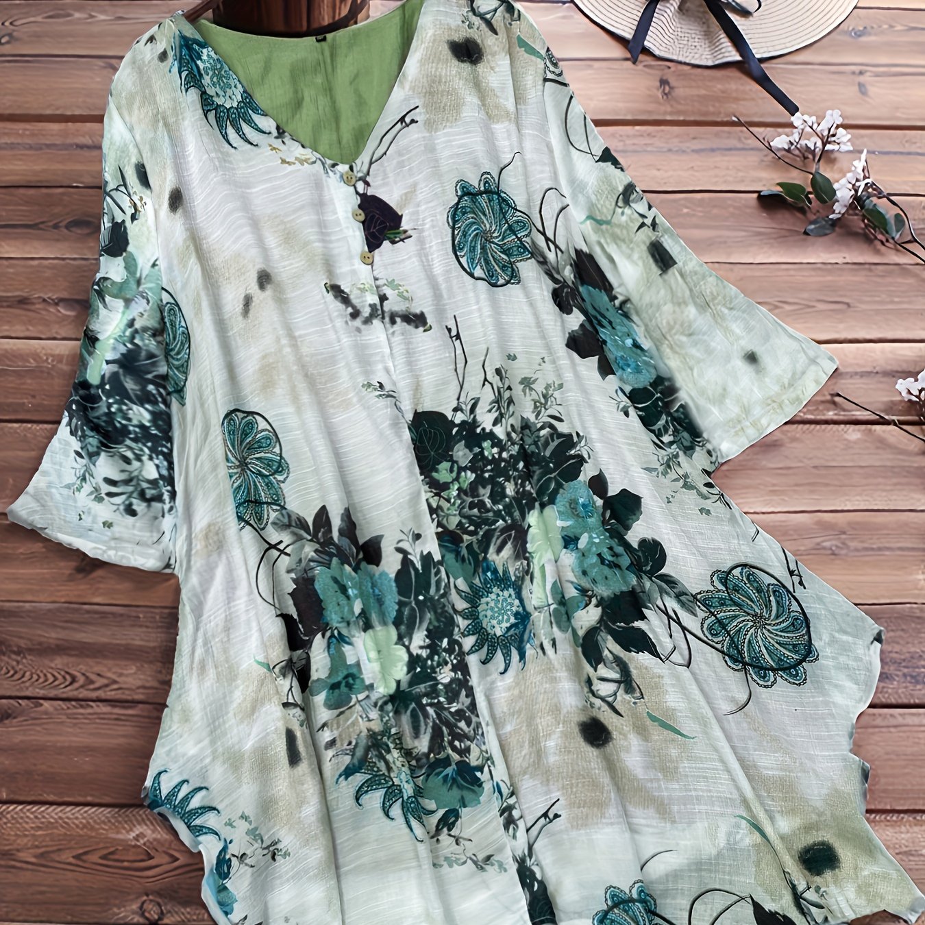 Women's plus size casual top with floral print, short sleeves, V-neck, and asymmetrical hem.