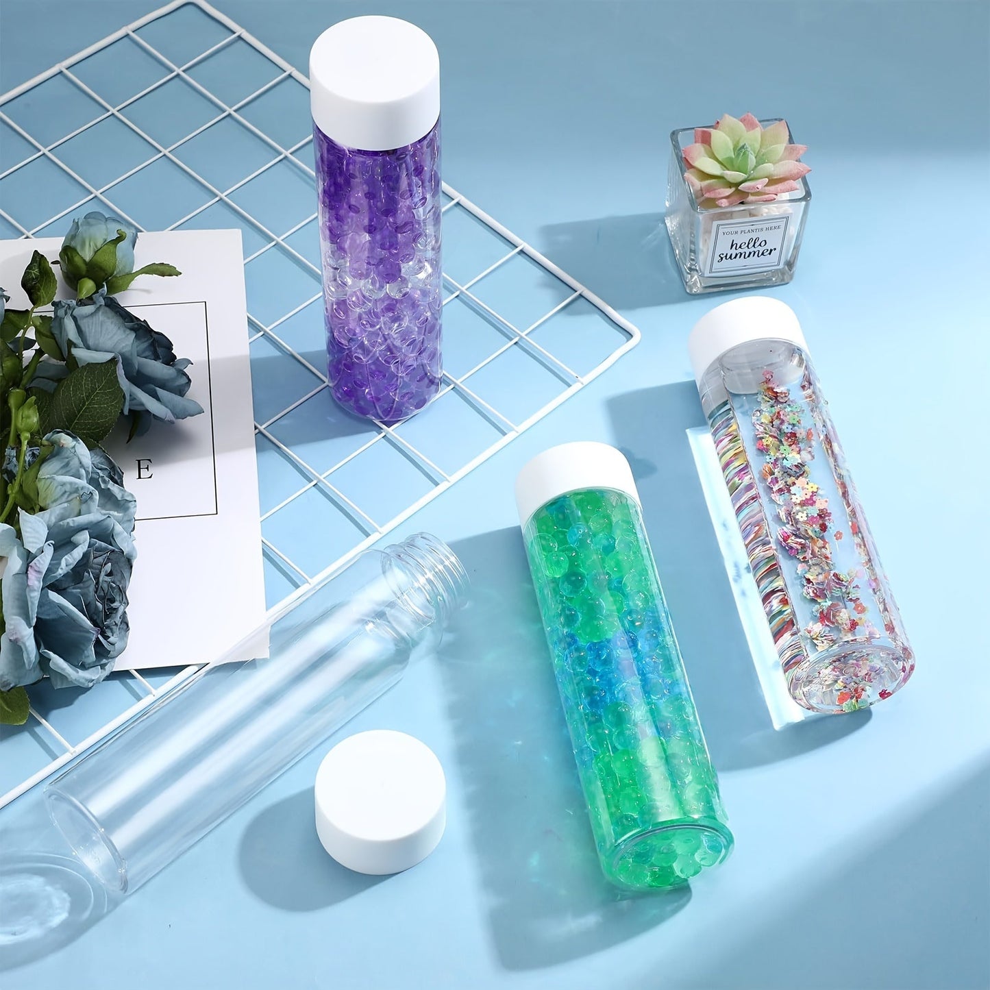 Six clear plastic sensory bottles with lids, each holding 10oz. These reusable water bottles are uncoated and perfect for classroom use, handmade crafts, and party supplies.