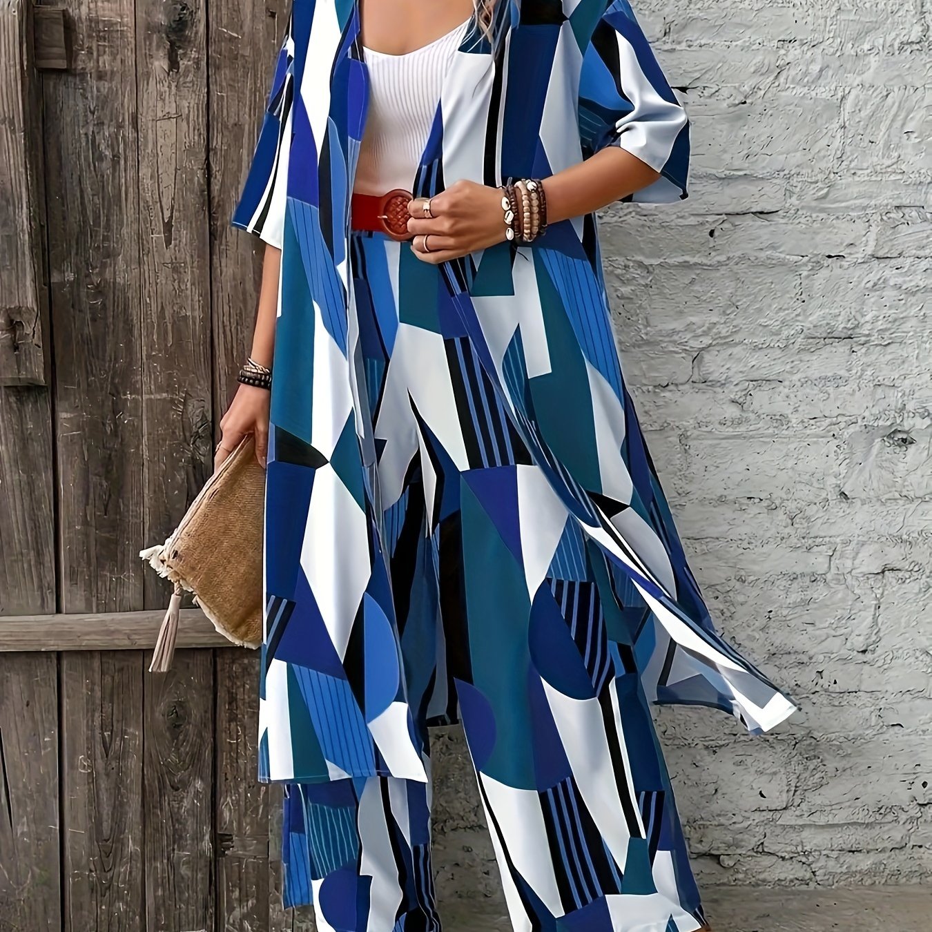 Stylish plus-size geometric print ensemble includes open front shirt, wide-leg pants made of elegant polyester. Perfect for fashion-forward ladies, machine washable.