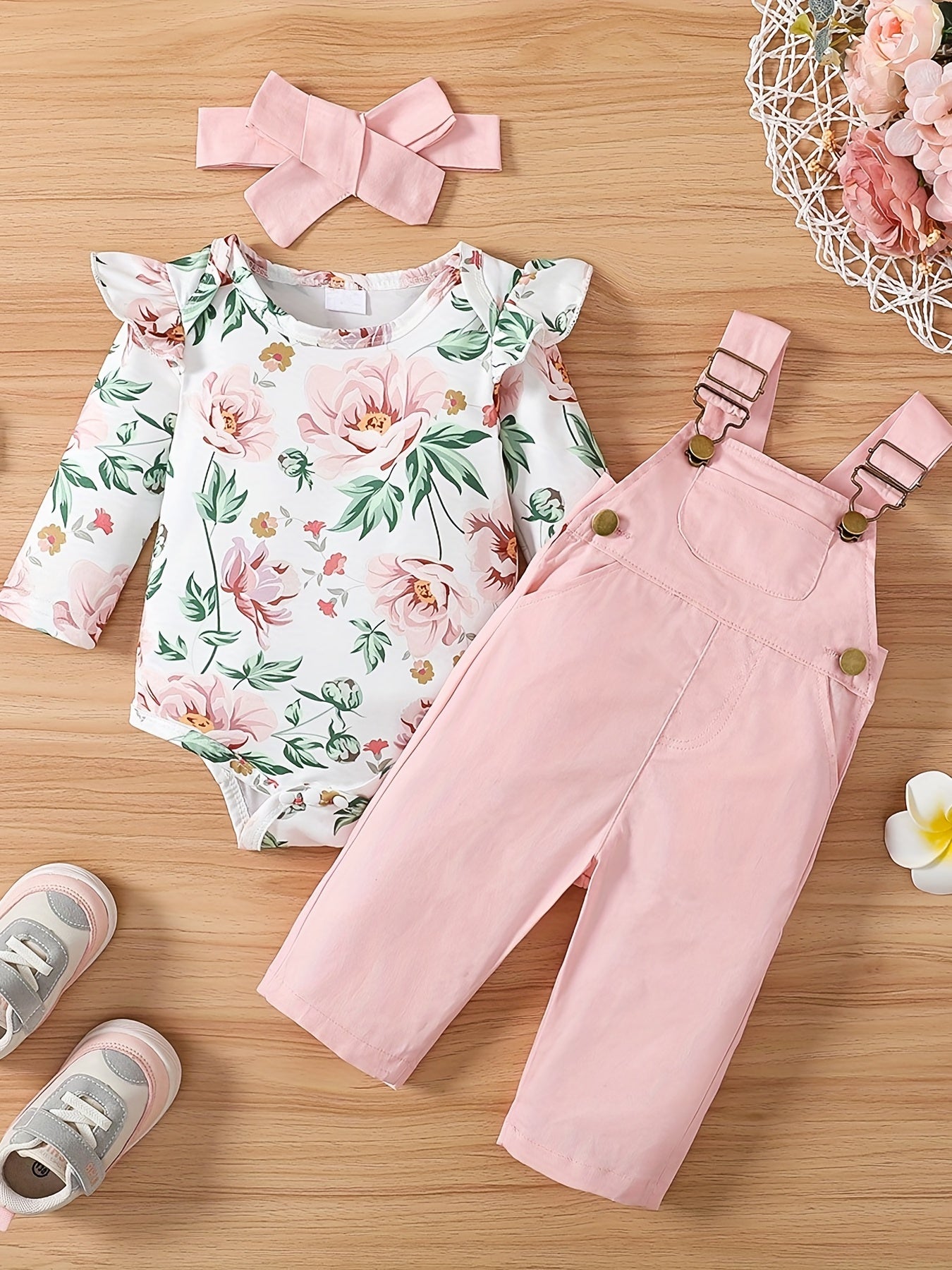 Girls 3-piece cotton set includes adjustable strap pants with pockets, floral print long sleeve romper with ruffle shoulder, and bow headband. Perfect for outdoor wear in spring/fall.