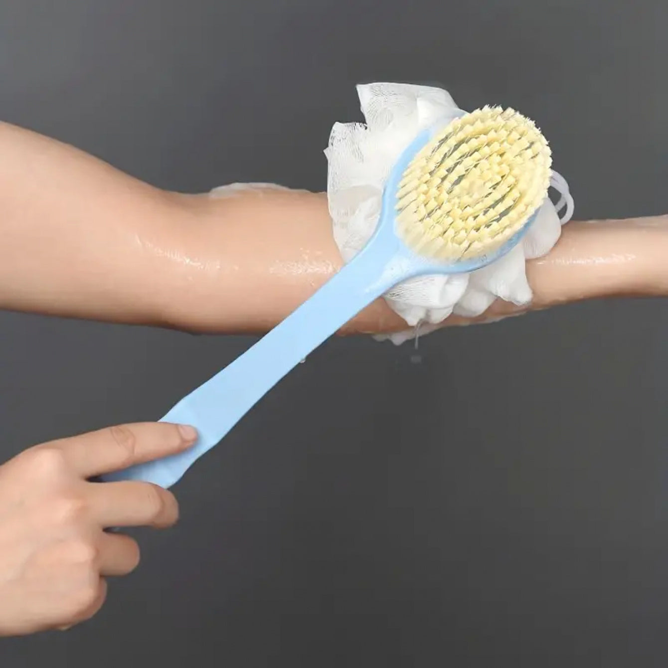 Dual colour exfoliating bath brush with long handle.