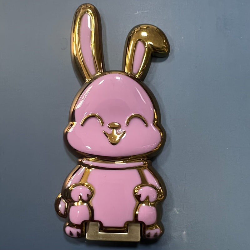 Foldable waterproof phone stand made of ABS material, featuring an adjustable cartoon bunny design for holding smartphones and tablets.