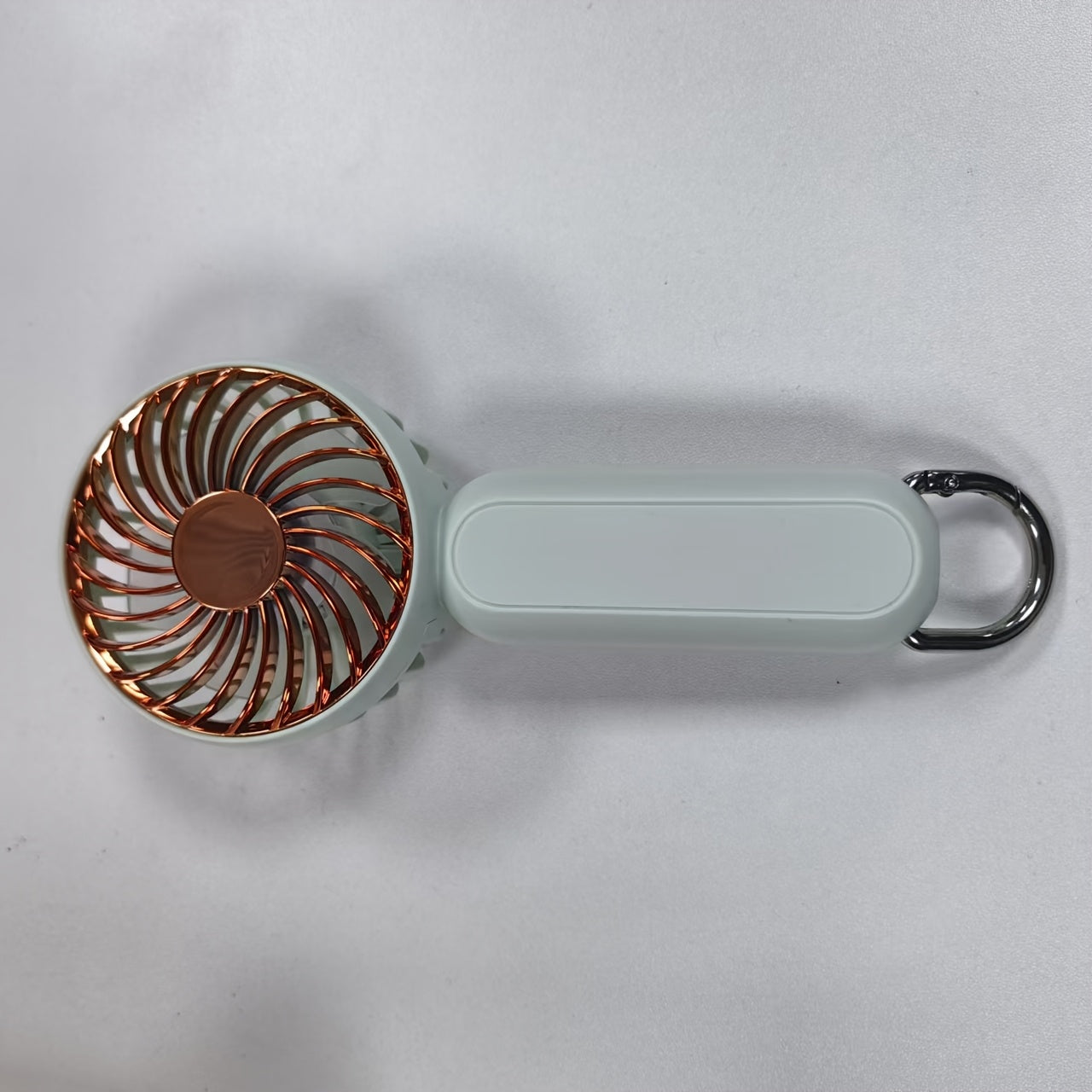 This mini portable fan is perfect for those on the go. It is handheld, personal, USB rechargeable, and battery-operated. You can bring it to the office, bedroom, outdoor travel, and camping. It also comes with a hook loop for easy carrying and