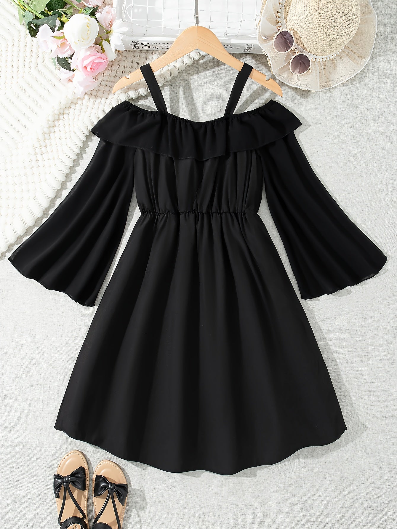 Black chiffon dress with off-shoulder ruffle detail, perfect for casual summer style.