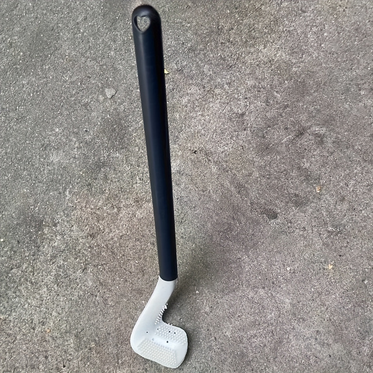 Golf toilet brush with long handle for wall mounting in household bathrooms.