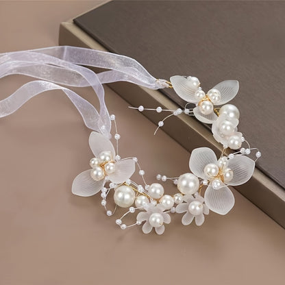 Romantic bridal headpiece with faux pearls, floral wreath, and ribbon tie.