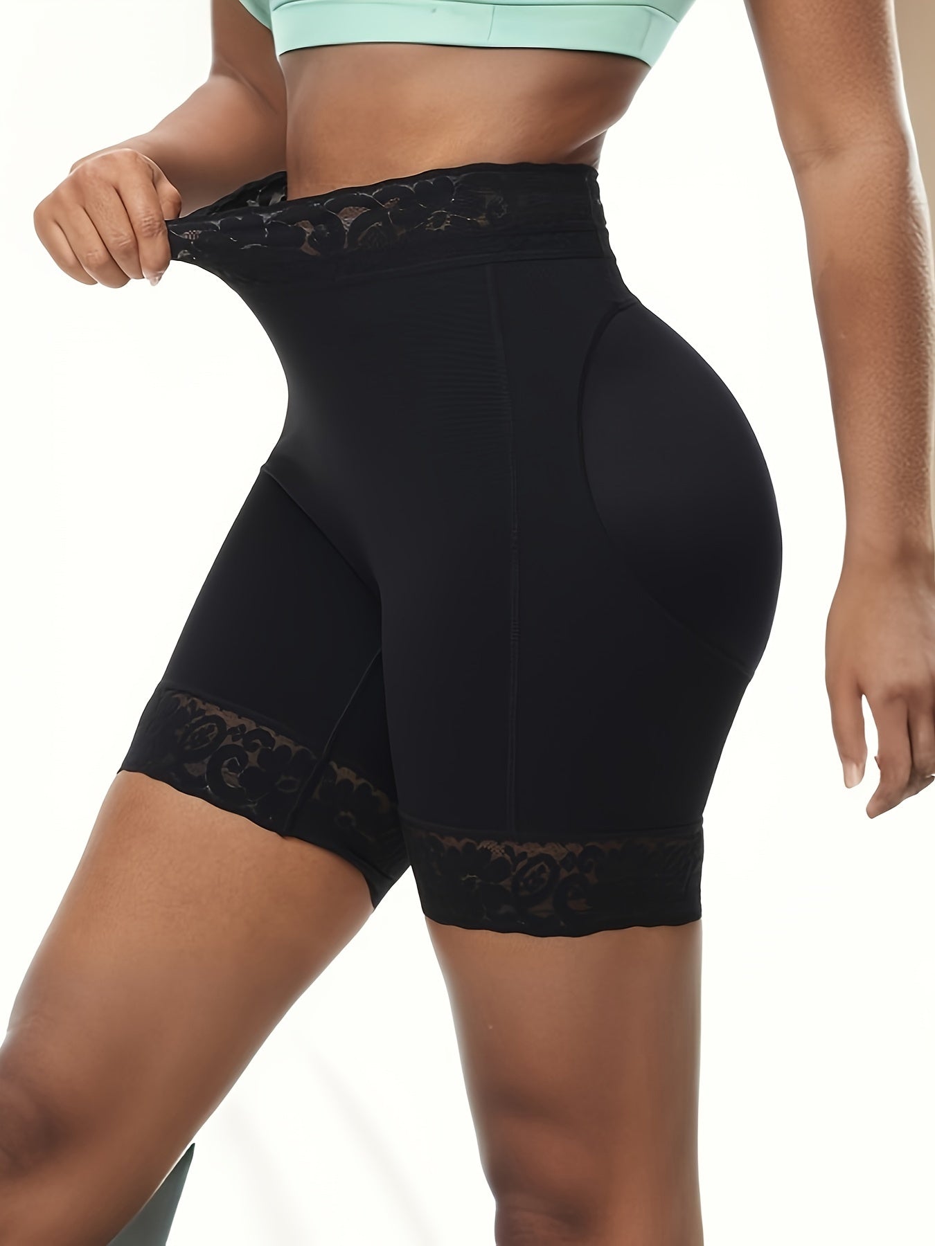 Women's high-waist shaping shorts with lace trim, tummy control, and butt lifting. Made from a breathable nylon/elastane blend with a seamless body sculpting design and floral lace detail.