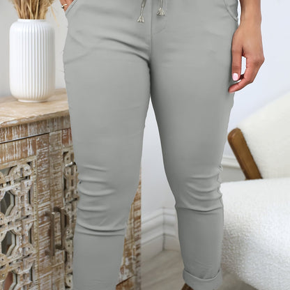 Women's comfortable jogger pants made of stretchy polyester with a drawstring waist, solid color, and machine washable for all-season wear.